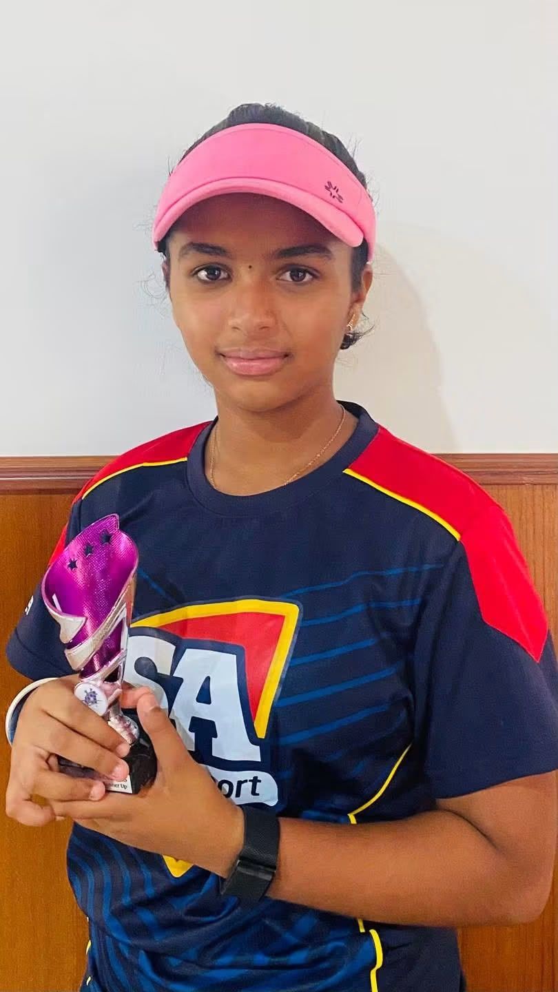 A junior player holding a runner-up trophy